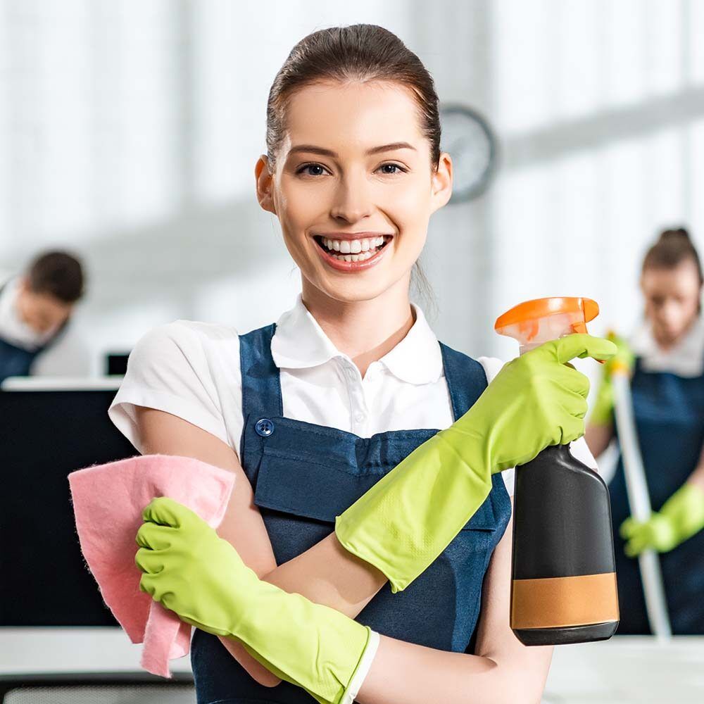 Smiling Professional Female Cleaners Washing Apartment With Rags